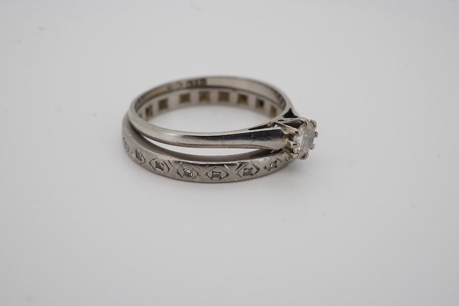 Two diamond rings, early 20th century, comprising: a solitaire ring set with an antique circular-cut diamond weighing approximately 0.15 carats, size O, stamped 18CT; and an eternity ring set with single-cut diamonds, si